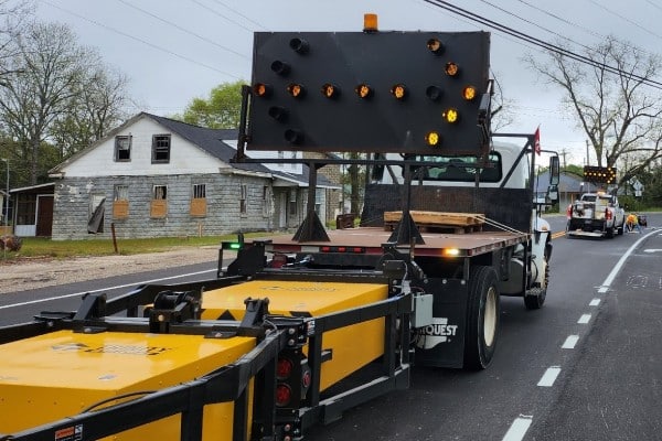 Ozark Striping traffic control truck with crash attenuator and arrow board deployed during active roadway striping operations