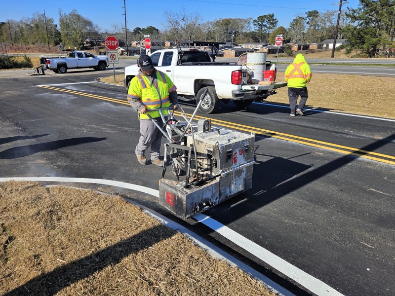 Ozark Striping employee applying thermoplastic pavement markings—showcasing hands-on career opportunities in roadway safety and striping services